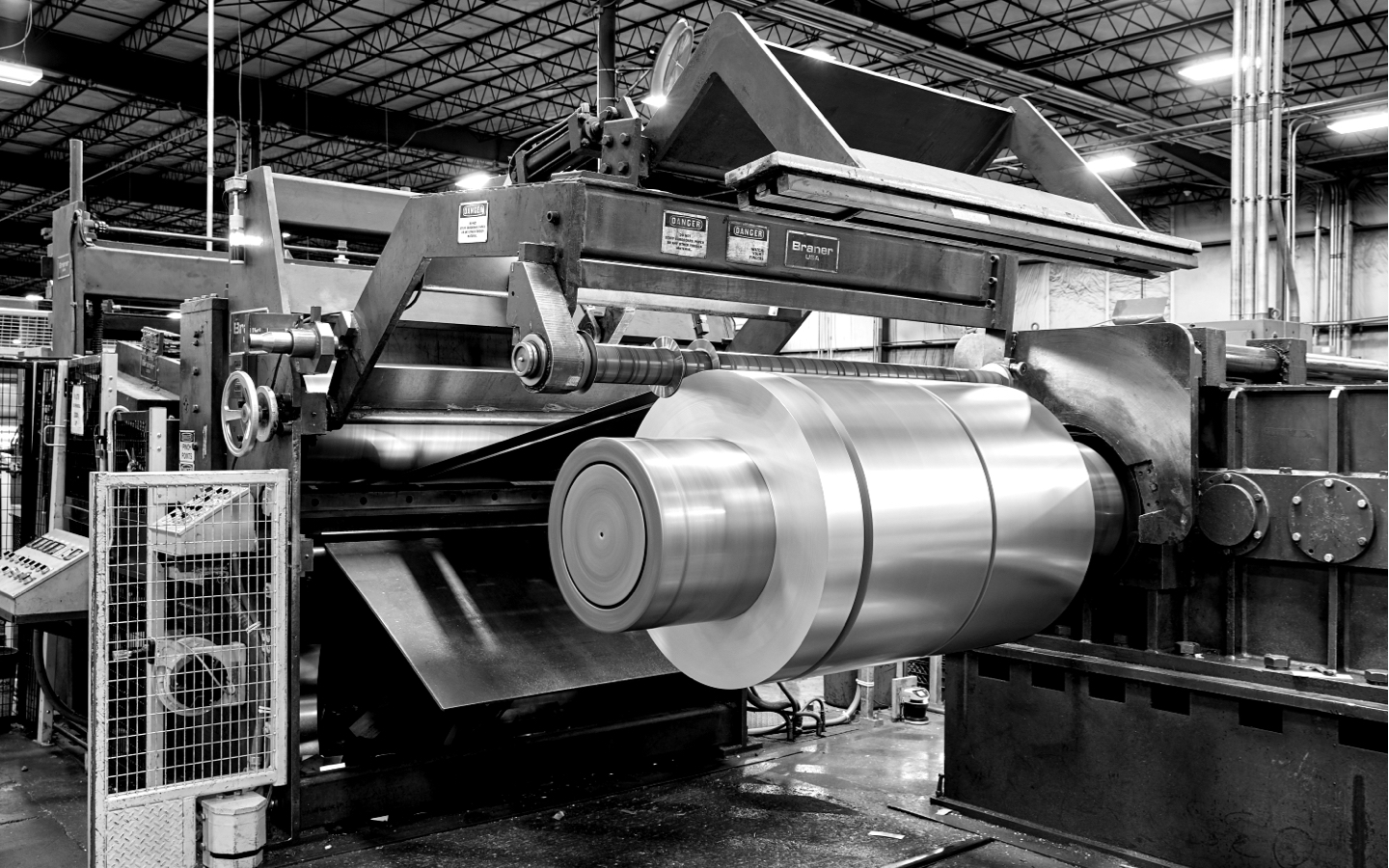 black and white image of steel being processed on a machine