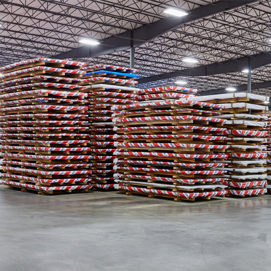 Sheets of Galvanized Steel Wrapped and Stacked in a Warehouse