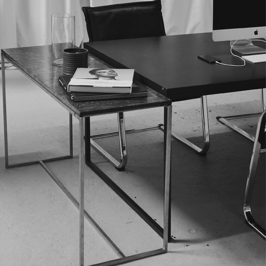 black and white image of cold rolled steel being used in the making of a desk