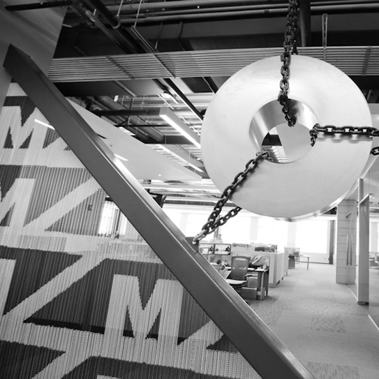 Coil hung by chains in our MAJESTIC STEEL USA Pepper Pike Office. This symbolizes that a team is only as strong as its weakest link. Showcasing the need to support one another and work together.