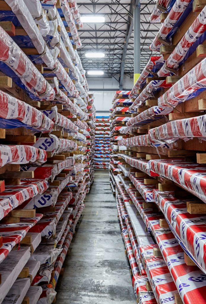 Rows of packaged red, white and blue sheets of prime steel