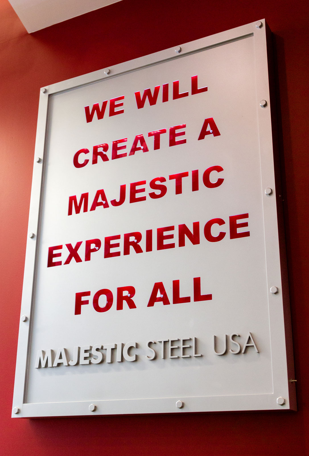 colored image of a sign in the majestic steel office that reads "We will create a majestic experience for all."